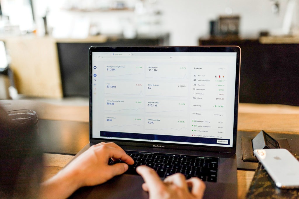 person looking at analytics on a laptop