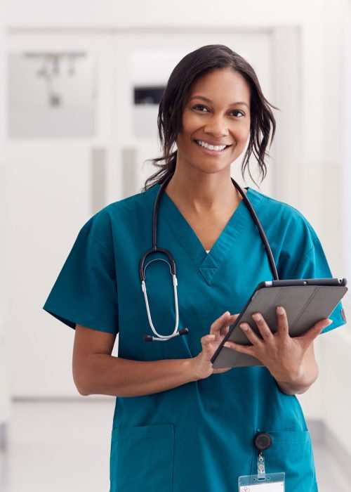 a smiling nurse with a tablet